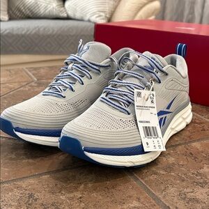 Never worn size 9 men’s Reeboks.  Grey with blue accents.